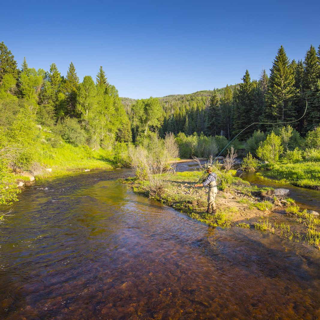 Fly fishing in Yampa river man on river island