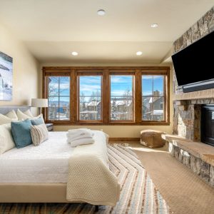 bedroom with fireplace and tv